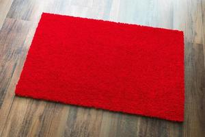 Blank Red Welcome Mat On Wood Floor Background Ready For Your Own Text photo