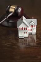 Gavel and Small Model House on Table photo