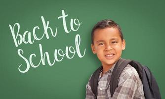 Hispanic Boy In Front of Back To School Chalk Board photo