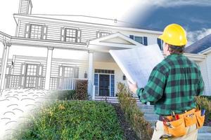 Male Contractor with Hard Hat and Tool Belt Looking At Custom House Drawing Photo Combination On White.