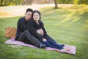 Pregnant Hispanic Couple in The Park Outdoors photo