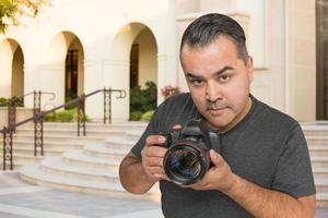Hispanic Young Male Photographer With DSLR Camera Outdoors photo