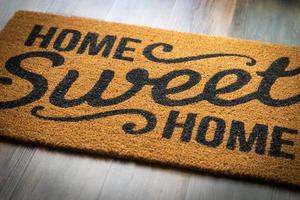 Home Sweet Home Welcome Mat Resting on Floor photo