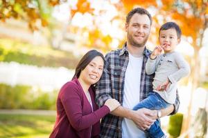 Outdoor portrait of Multiethnic Chinese and Caucasian family. photo