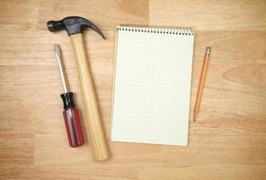 Pad of Paper, Pencil, Hammer and Screwdriver photo
