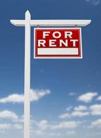 Right Facing For Rent Real Estate Sign on a Blue Sky with Clouds. photo