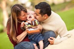 Happy Mixed Race Parents Playing with Their Son photo