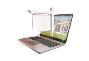 Blank Real Estate Sign Popping Out of Computer Laptop Screen Isolated on a White Background photo