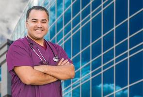 Hispanic Male Nurse In Front Of Hospital Building photo