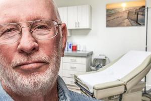 Worried Senior Adult Man Waiting in Doctor Office photo