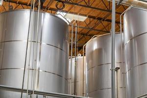 Large Beer Brewery Fermentation Tanks in Warehouse photo