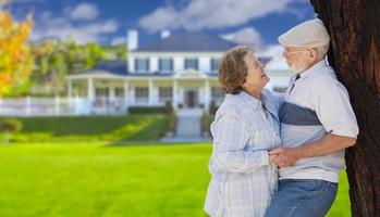 Happy Senior Couple in Front Yard of House photo