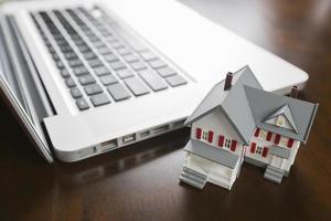 Miniature House And Laptop Computer photo