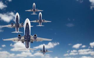 Bottom View of Several Passenger Airplanes Flying In The Blue Sky photo