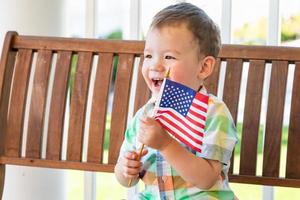 Young Mixed Race Chinese and Caucasian Boy Playing With American Flag photo