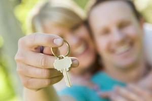 Happy Couple Holding Blank House Key Outside photo