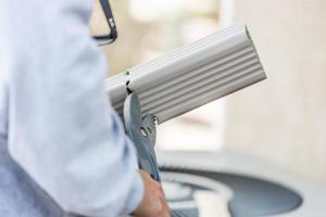 Worker Cutting Aluminum Rain Gutter With Heavy Shears photo