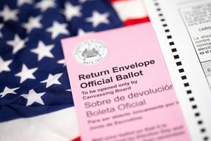 Vote-By-Mail Ballot Envelope Laying on American Flag photo