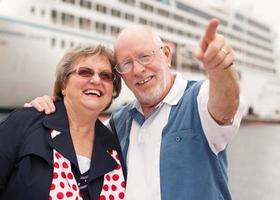 Senior Couple On Shore in Front of Cruise Ship photo