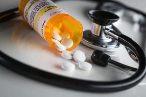 Non-Proprietary Medicine Prescription Bottles and Spilled Pills with Stethoscope photo