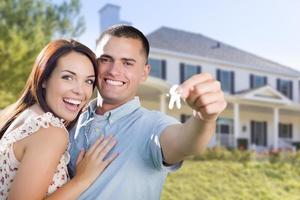 Military Couple with House Keys In Front of New Home photo