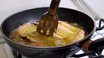 Cooking fish. Frying mullet fish in a pan. Delicious tasty cuisine. video