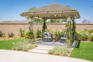 Beautiful Yard Pergola Patio Cover with Chairs. photo