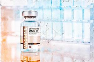 Artistic Rendering Sketch of Coronavirus COVID-19 Vaccine Vial and Test Tubes On Reflective Surface photo