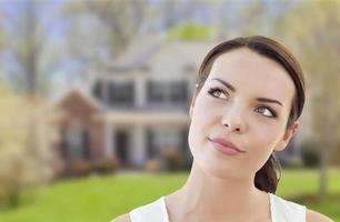 Thoughtful Mixed Race Woman In Front of House photo