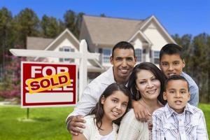 Hispanic Family in Front of Sold Real Estate Sign, House photo