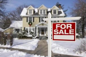 Home For Sale Sign in Front of Snowy New House photo