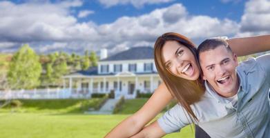 Playful Young Military Couple Outside Beautiful Home photo