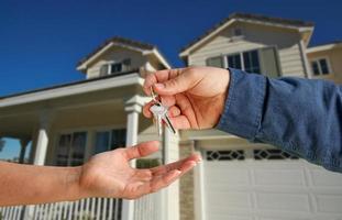 Handing Over the House Keys in Front of New Home photo