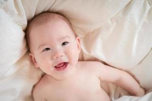 Mixed Race Baby Boy Having Fun on His Blanket photo