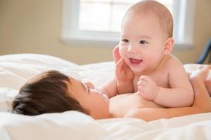 Mixed Race Chinese and Caucasian Baby Brothers Having Fun Laying on Their Blanket photo