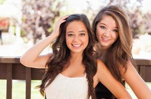 Two Mixed Race Girlfriends Pose for Portrait Outdoors photo