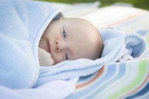 Little Baby Boy Resting in His Warm Blanket photo