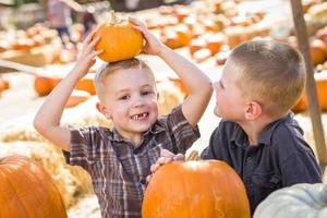 Two Boys at the Pumpkin Patch Talking and Having Fun photo