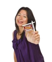 Multiethnic Woman Holding Small Sold Real Estate Sign photo