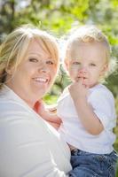 Young Mother Holding Her Adorable Baby Boy photo