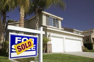 Blue Sold For Sale Real Estate Sign and House photo