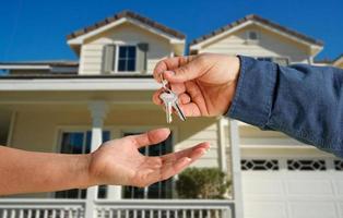 Handing Over the House Keys in Front of New Home photo