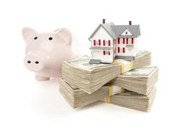 Small House and Piggy Bank with Stacks Money photo