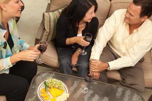 Three Friends Enjoying Wine on the Patio photo