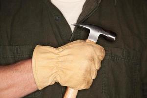 Man with Leather Construction Glove Holding Hammer photo
