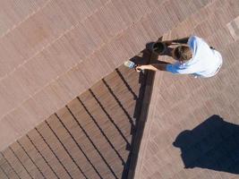 Professional Painter Using A Brush to Paint House Fascia photo