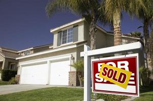 Red Sold For Sale Real Estate Sign and House photo