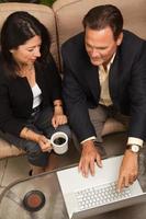 Man and Woman Using Laptop with Coffee photo