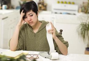 Multi-ethnic Young Woman Agonizing Over Financial Calculations photo