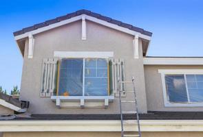 Ladder Leaning Up Against A House Ready For New Paint photo